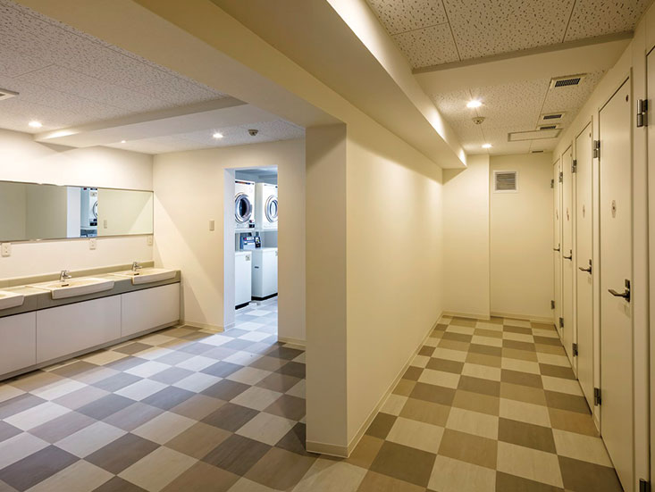 Shower booth, washroom, and coin laundry